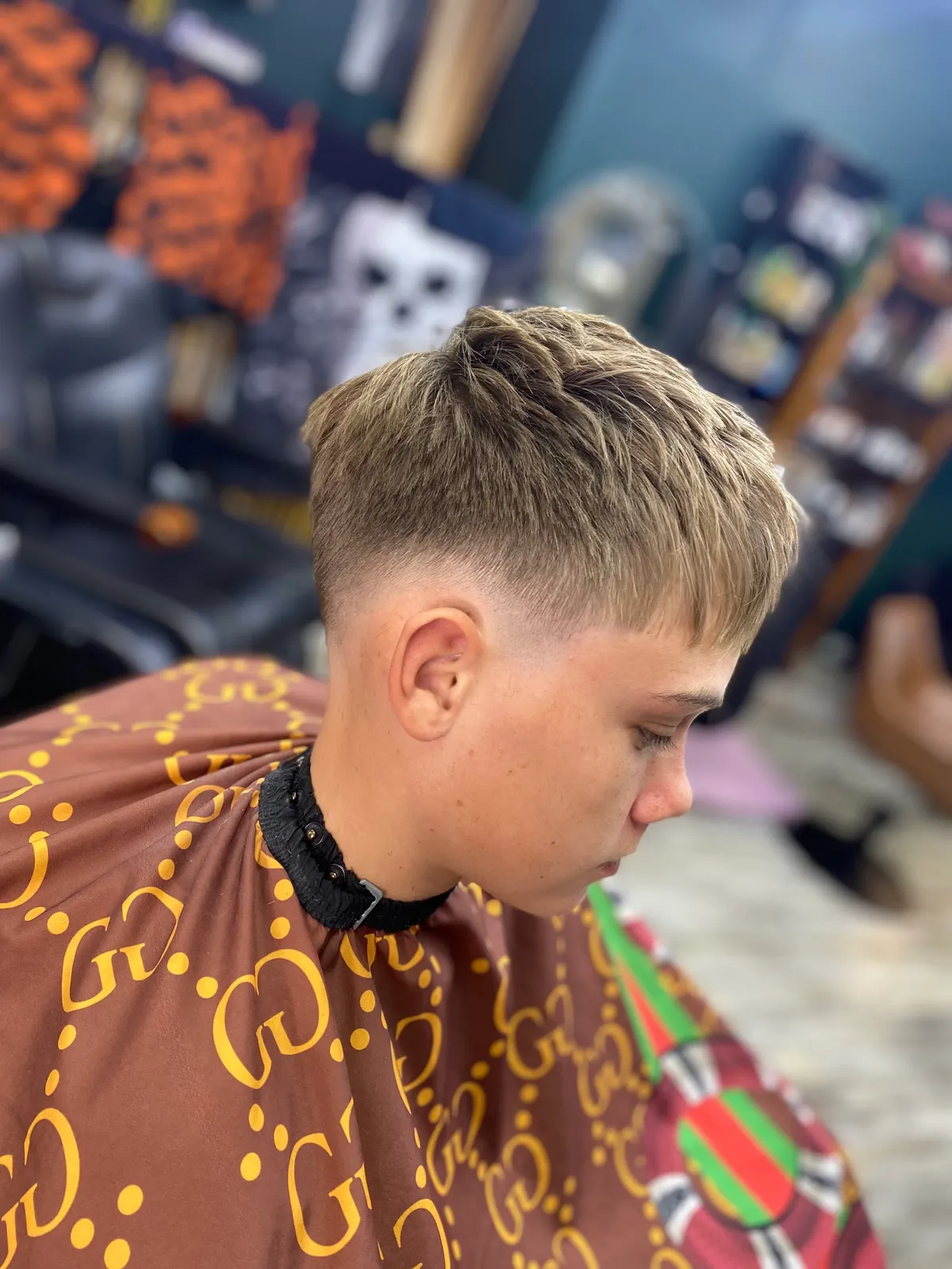 Profile of a textured crop fade haircut on a young client at Bear Cave Barbershop