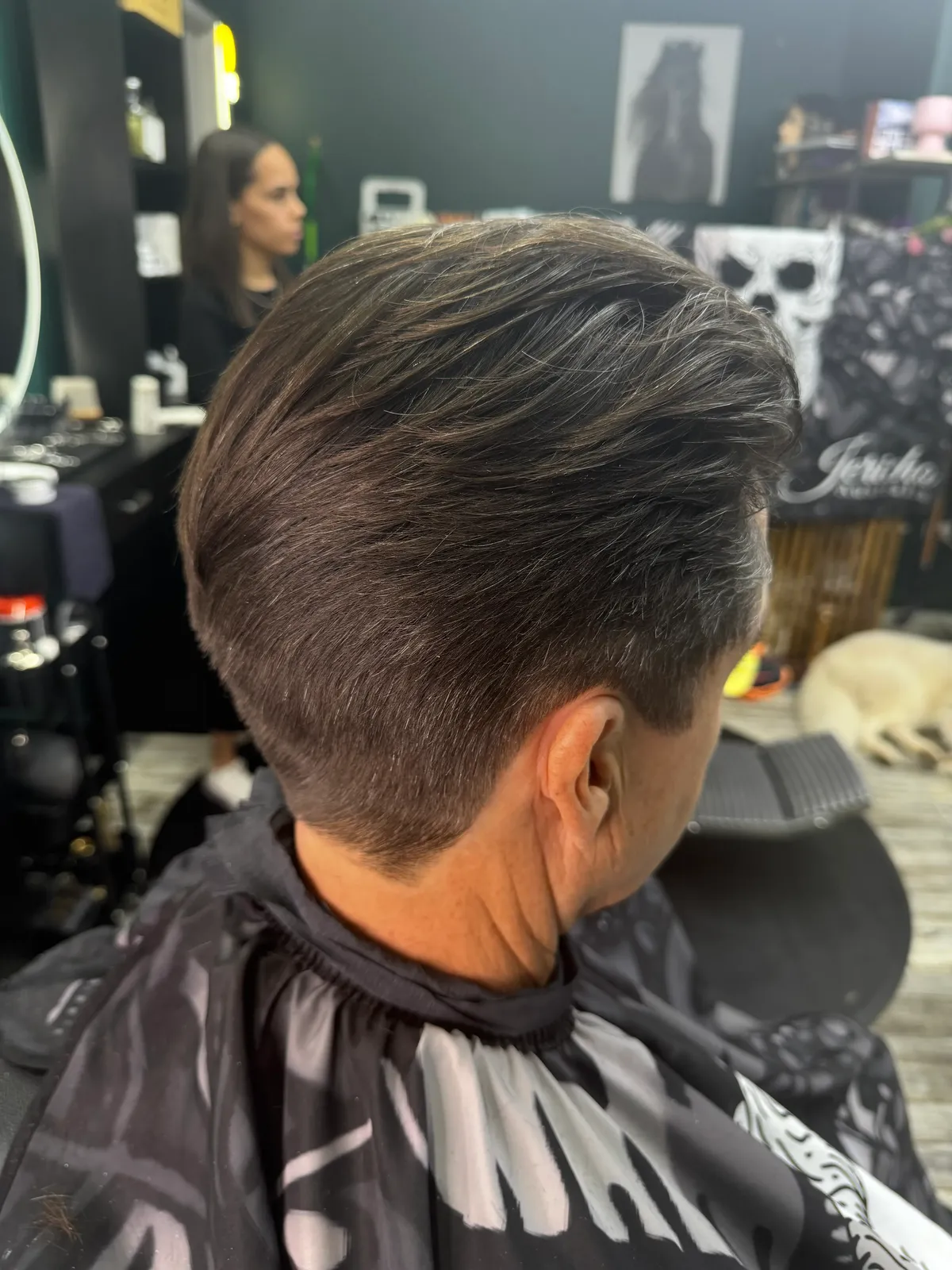Back view of a short, swept-back haircut at Bear Cave Barbershop